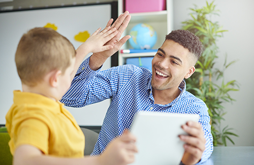 Student and teaching giving each other a high-five