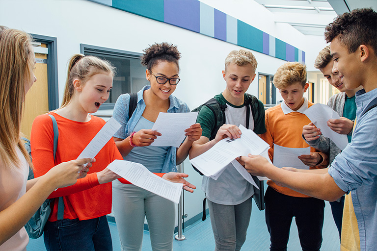 Happy students looking at grades